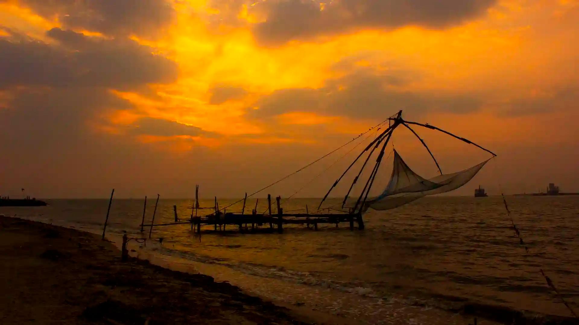Chinese fishing nets silhouetted at sunset in Fort Kochi, Kerala